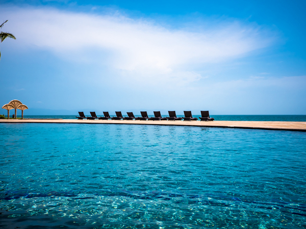 sandbar lined with beach chairs in puerto vallarta